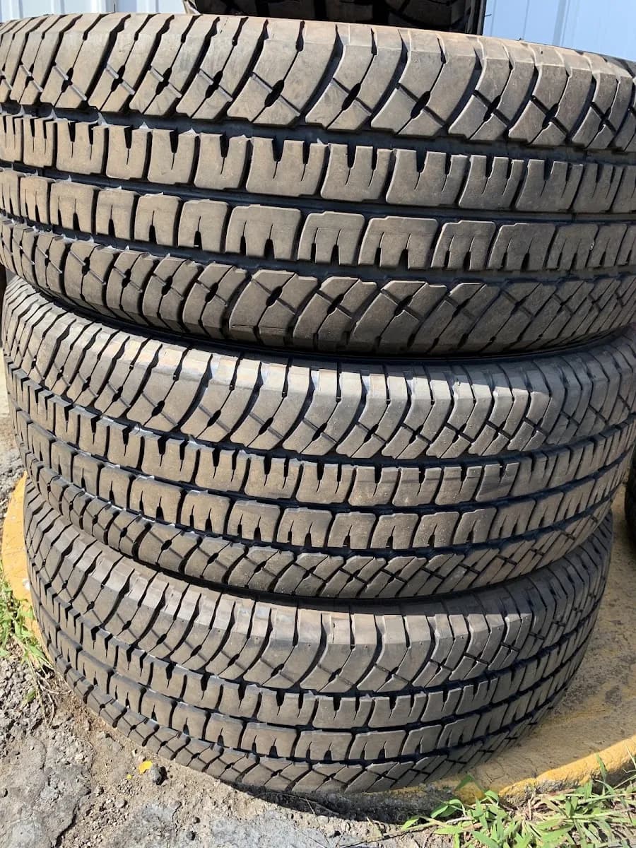 A stack of used tires with deep tread